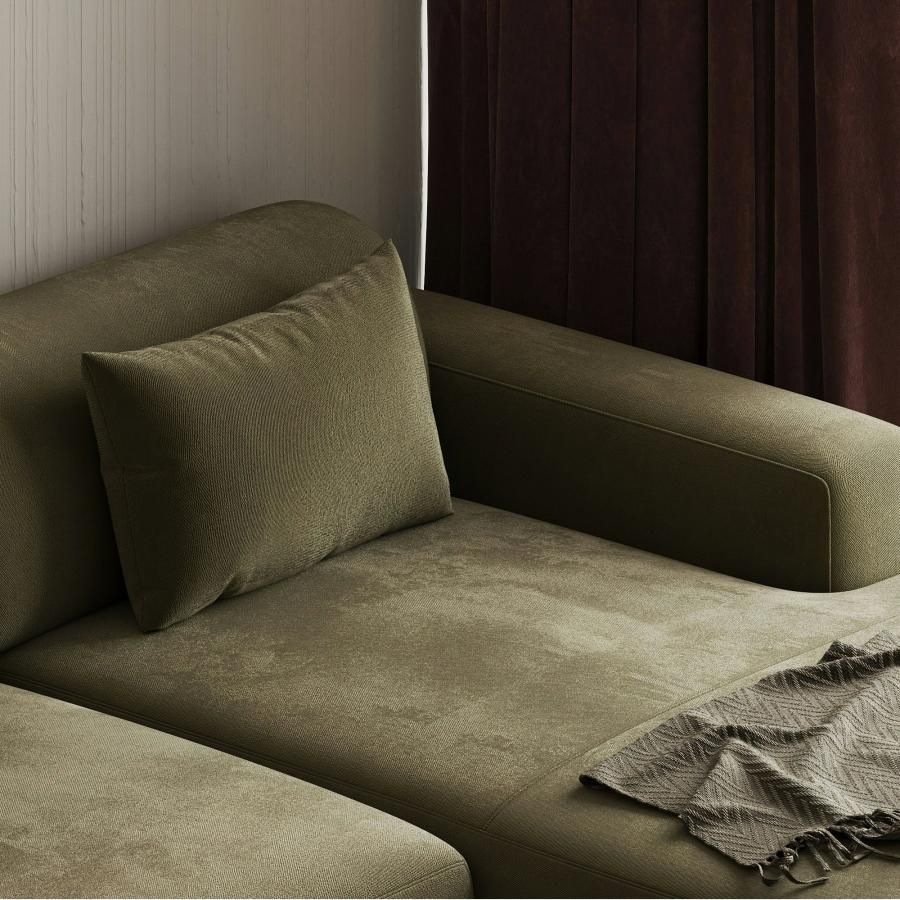 a green couch with pillows